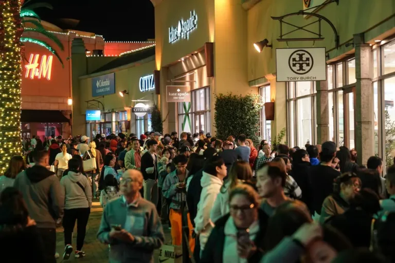 Photos show Black Friday crowds at retailers across the US even as more shoppers move online